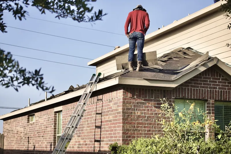 Professional roofer working on a residential roof in Sherrill